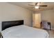 Bedroom featuring a ceiling fan, a bed with a leather headboard, and a desk at 1727 Shire Village Dr, Sugar Hill, GA 30518