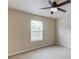 Bright bedroom featuring a ceiling fan and a window providing natural light at 1727 Shire Village Dr, Sugar Hill, GA 30518