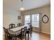 Formal dining room with a wooden table and chairs, hardwood flooring, and a chandelier light fixture at 1727 Shire Village Dr, Sugar Hill, GA 30518