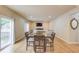 Light-filled dining room area with wood floors and a large sliding glass door to the deck at 1727 Shire Village Dr, Sugar Hill, GA 30518