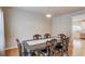 Formal dining room featuring hardwood floors, a large dining table with six chairs, and a view of the kitchen at 1727 Shire Village Dr, Sugar Hill, GA 30518