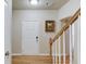 Foyer with hardwood floors, white door, and light-colored walls with white trim and staircase with wood railing at 1727 Shire Village Dr, Sugar Hill, GA 30518
