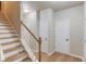 Hallway with hardwood floors leading to the staircase at 1727 Shire Village Dr, Sugar Hill, GA 30518