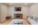 Living room area featuring hardwood floors and a decorative fireplace at 1727 Shire Village Dr, Sugar Hill, GA 30518