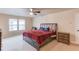 Spacious main bedroom with natural light, carpet floors, and a fan at 1727 Shire Village Dr, Sugar Hill, GA 30518