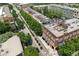 A high-angle aerial view of a brick building with a rooftop patio overlooks a tree-lined street with other brick buildings at 422 Bill Kennedy Se Way, Atlanta, GA 30316