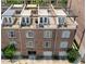 Aerial view of brick townhomes featuring rooftop terraces, garages, and well-maintained exterior facades at 422 Bill Kennedy Se Way, Atlanta, GA 30316