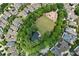 A high-angle aerial showcases a lush community green space, complete with a pond, playground, and surrounding residential homes at 422 Bill Kennedy Se Way, Atlanta, GA 30316