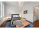 This bright bedroom has a charming light fixture and hardwood floors at 422 Bill Kennedy Se Way, Atlanta, GA 30316