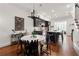 Elegant dining area with hardwood floors, a modern chandelier, a kitchen island and white walls at 422 Bill Kennedy Se Way, Atlanta, GA 30316