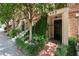 Charming townhome entrance featuring brick pathway, lush greenery, and a secure gated doorway at 422 Bill Kennedy Se Way, Atlanta, GA 30316