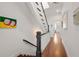 Hallway with hardwood floors, staircase with white railings, and black stained banister at 422 Bill Kennedy Se Way, Atlanta, GA 30316