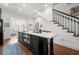 Kitchen island featuring black cabinets and barstool seating; stainless steel appliances included at 422 Bill Kennedy Se Way, Atlanta, GA 30316