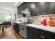 Modern kitchen with dark cabinets, stainless appliances, a marble countertop, and gas range at 422 Bill Kennedy Se Way, Atlanta, GA 30316