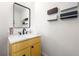 Bright powder room with yellow vanity cabinet, marble countertop, and black framed mirror at 422 Bill Kennedy Se Way, Atlanta, GA 30316