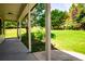 Covered patio showing a vast and lush backyard with plenty of greenery at 5427 Highway 81, Loganville, GA 30052