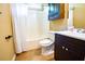 Bright bathroom featuring a shower-tub combination and dark wood vanity at 5427 Highway 81, Loganville, GA 30052