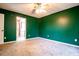 Spacious bedroom featuring plush carpeting and vibrant green walls at 5427 Highway 81, Loganville, GA 30052