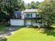 Two-story home with attached garage, complemented by a well-maintained lawn and mature trees, creating a welcoming curb appeal at 5427 Highway 81, Loganville, GA 30052