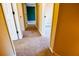 Hallway with carpet, multiple doors, and neutral paint, creating a welcoming space at 5427 Highway 81, Loganville, GA 30052