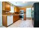 Well-equipped kitchen showcasing stainless steel appliances and classic wooden cabinetry at 5427 Highway 81, Loganville, GA 30052