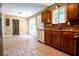 Charming kitchen with tile floors, wooden cabinets, and a window over the sink at 5427 Highway 81, Loganville, GA 30052