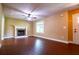 Bright living room featuring a cozy fireplace, ceiling fan, and beautiful wood floors, perfect for unwinding after a long day at 5427 Highway 81, Loganville, GA 30052