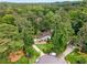 Aerial view of a charming home nestled among lush green trees, surrounded by beautiful landscaping and curb appeal at 5714 Braddock Ct, Atlanta, GA 30350