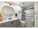 Updated bathroom featuring a glass-enclosed shower, modern vanity, and stylish lighting at 5714 Braddock Ct, Atlanta, GA 30350