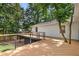 Expansive deck featuring modern railings and a unique design incorporating mature trees at 5714 Braddock Ct, Atlanta, GA 30350