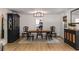 Elegant dining room with antique furniture, decorative mirror, and modern lighting at 5714 Braddock Ct, Atlanta, GA 30350