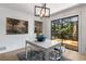 Dining room with modern light fixture and sliding glass door to outdoor deck at 5714 Braddock Ct, Atlanta, GA 30350