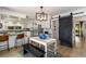 Open concept dining room featuring stylish lighting, kitchen view and barn door at 5714 Braddock Ct, Atlanta, GA 30350