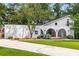 Inviting white home with arched porch, manicured lawn, and an American flag at 5714 Braddock Ct, Atlanta, GA 30350
