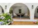 Cozy arched front porch with comfortable seating and decorative flowers in a beautiful setting at 5714 Braddock Ct, Atlanta, GA 30350