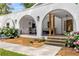 Arched front porch showcasing outdoor seating, stylish lighting, and colorful landscaping at 5714 Braddock Ct, Atlanta, GA 30350