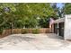 View of the garage, featuring a traditional design, complemented by a wooden fence and a driveway at 5714 Braddock Ct, Atlanta, GA 30350