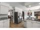 Open kitchen layout with stainless steel appliances and access to dining room at 5714 Braddock Ct, Atlanta, GA 30350