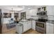 Modern kitchen featuring stainless steel appliances, granite countertops, and a dining area at 5714 Braddock Ct, Atlanta, GA 30350