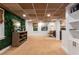 Finished basement with unique ceilings, an accent plant wall, and stylish decor for a comfortable living space at 5714 Braddock Ct, Atlanta, GA 30350