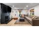 Spacious living room with a fireplace, large sectional, and ample natural light at 5714 Braddock Ct, Atlanta, GA 30350