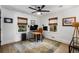 Bright home office with a modern ceiling fan, natural light, and a cozy rug for a productive workspace at 5714 Braddock Ct, Atlanta, GA 30350