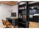 Basement office with a black desk and hutch near an adjacent bedroom for convenience and privacy at 5714 Braddock Ct, Atlanta, GA 30350