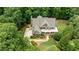 A stunning aerial view of a home with meticulous landscaping and mature trees at 930 Shepards Ct, Roswell, GA 30075