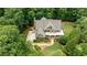 Aerial view displays home surrounded by greenery, showcasing landscaping, roof, and driveway at 930 Shepards Ct, Roswell, GA 30075