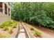 Beautiful backyard with stone walkway, lush landscaping, and wooded backdrop at 930 Shepards Ct, Roswell, GA 30075