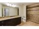 Modern bathroom with granite countertop, tile shower with glass doors, and neutral color palette at 930 Shepards Ct, Roswell, GA 30075
