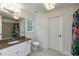 Bathroom featuring a granite countertop, large mirror, and a bathtub with a tiled shower at 930 Shepards Ct, Roswell, GA 30075