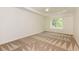 Empty bedroom featuring neutral carpeting, a ceiling fan and a window providing natural light at 930 Shepards Ct, Roswell, GA 30075