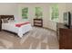 Bright bedroom with natural light features a bed, dresser, and multiple large windows at 930 Shepards Ct, Roswell, GA 30075